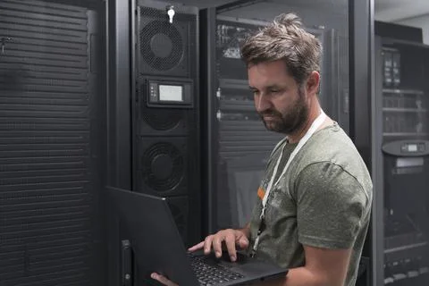 Data Center Engineer Using Laptop Computer Server Room Specialist Facility with Stock Photos