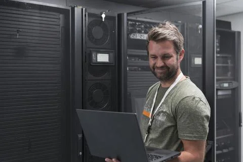 Data Center Engineer Using Laptop Computer Server Room Specialist Facility with Stock Photos