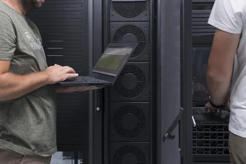 Data Center Engineer Using Laptop Computer. Server Room Specialist Facility with 스톡 사진