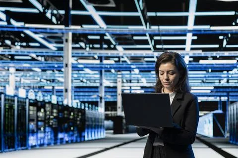 Data center engineer using laptop to do maintenance, VFX compositing overlay Foto stock