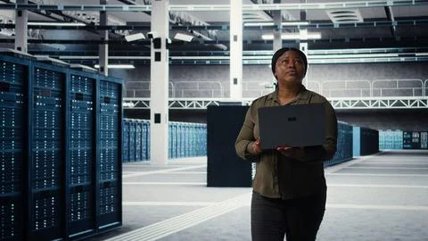 Data center engineer using laptop to develop disaster recovery plans Stock Photos