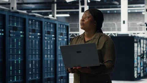 Data center engineer using laptop to develop disaster recovery plans Stock Photos