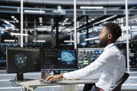 Data center engineer using machine learning algorithms on computer Stock Photos