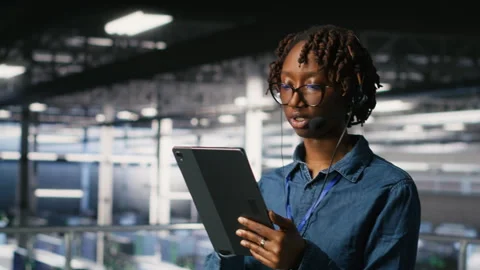 Data center engineer wearing headset microphone providing remote diagnostics Stock Footage 310277098