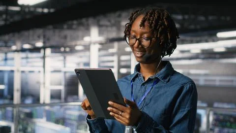 Data center engineer wearing headset microphone providing remote diagnostics Stock Photos