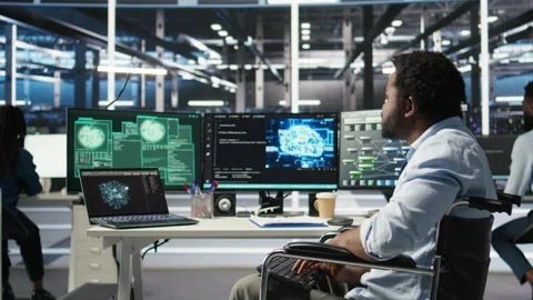 Data center engineer in wheelchair and coworkers fighting security breach Stock Footage 309509730