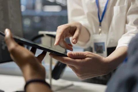 Data center engineering team analyzing software logs metrics on tablet, close up Stock Photos