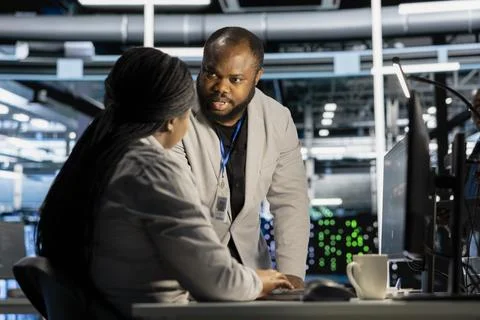 Data center engineering team running diagnostic scripts on computer Stock Photos