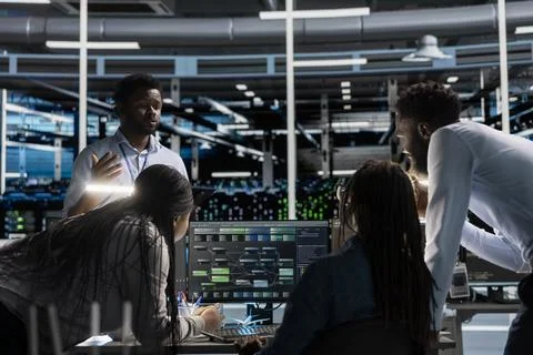 Data center engineering team using PC to visualize AI neural networks node trees Stock Photos