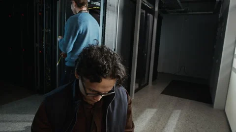 Data Center Engineers Configuring Servers and Connecting Network Cable Stock Footage 330546226