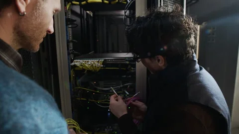 Data Center Engineers Discussing Server Installation with Network Cables Stock Footage 330545033