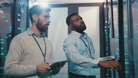 Data center engineers working in team opening rack server computers monitoring Stock Footage 119231589