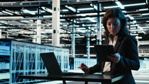 Data center female admin uses device and AR simulation to conduct security audit Stock Footage 329329052