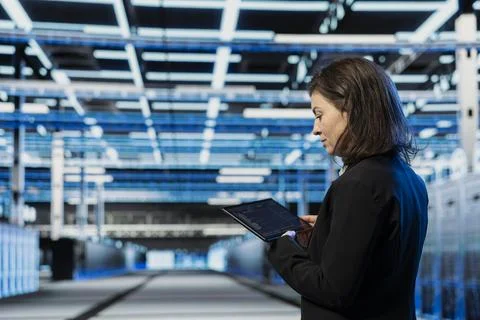 Data center female developer using programming script on tablet Stock-Fotos