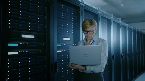 In Data Center: Female IT Technician Running Maintenance Programme on a Laptop Stock Footage 101174557