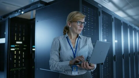 In Data Center: Female IT Technician Running Maintenance Programme on a Laptop Stock Footage 101174737