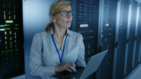 In Data Center: Female IT Technician Running Maintenance Programme on a Laptop Stock Footage 101174957