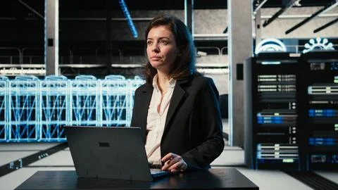Data center female programmer uses laptop and AR virtualization Stock-Fotos