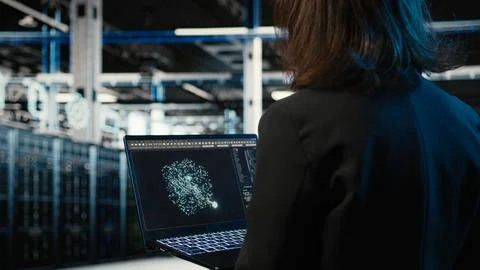 Data center female programmer using AI LLM model on laptop Stock-Fotos