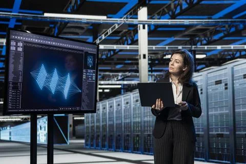Data center female programmer using artificial intelligence chatbot Stock Photos