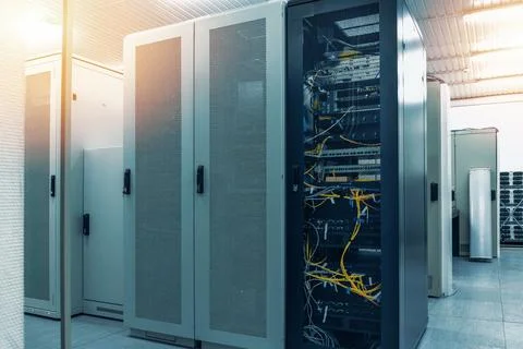 Data center infrastructure with server racks and network cabinets inside Stock Photos