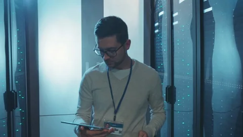 Data center IT administrator opening rack server cabinet checking hardware Stock Footage 119234216