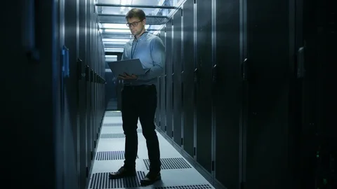 In Data Center IT Engineer Stands Before Working Server Rack Doing Routine Work Stock Footage 101277320