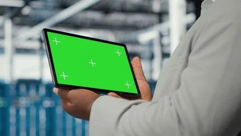 Data center IT expert uses mockup tablet, reviewing rigs performance, closeup Foto stock