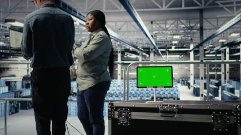 Data center IT professionals check AI dashboard using isolated screen tablet Stock Footage 314804572