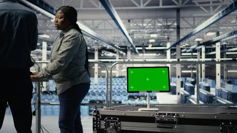 Data center IT professionals check AI dashboard using isolated screen tablet Foto stock