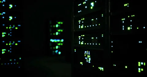 Data center lights illuminate technology and hardware in a darkened environment Stock Footage 307133091