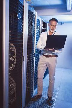 Data center, man and technician with laptop for cyber security, system Stock Photos