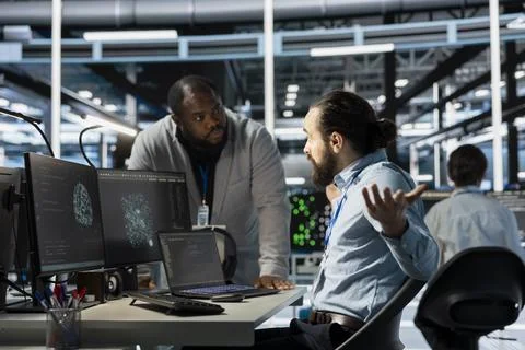 Data center manager berating employee, reproaching performance issues Stock Photos