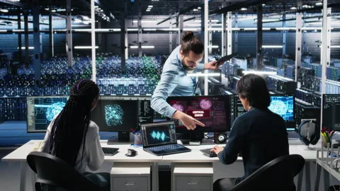 Data center manager coordinates programmers fixing critical error while using AI Stock Footage 313569641