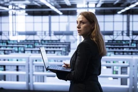 Data center manager ensuring safety and security of database using notebook Stock Photos