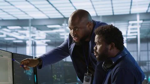 Data center manager helps intern implement AI predictive systems Stock Photos