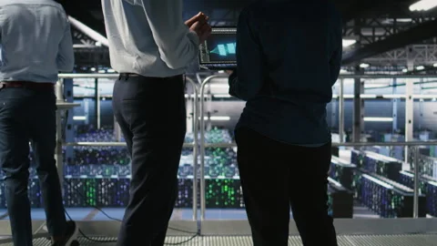 Data center manager overseeing work done by admin using AI LLM visualization Stock Footage 310787440