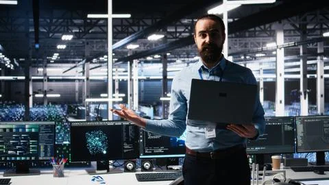 Data center manager showcasing AI technology, filming presentation video Stock Photos