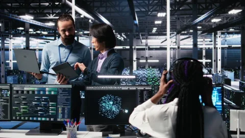 Data center manager supervising developer using device to monitor neural network Stock Footage 313570847