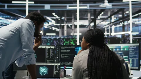 Data center manager supervising worker deploying AI solutions Stock Footage 307039789