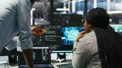 Data center manager supervising worker deploying AI solutions Stock Footage 307334071