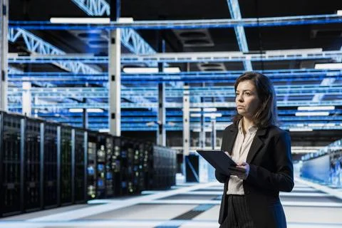 Data center manager using tablet, managing server virtualization Stock Photos