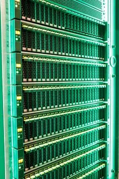 Data Center With Multiple Rows of Fully Operational Server Racks in server room Stock Photos