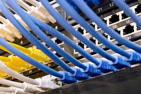 Data center, network panel, switch and connected cables Stock Photos