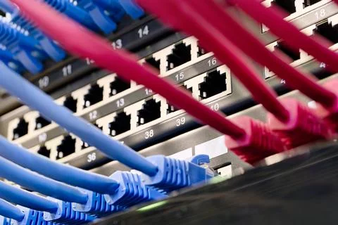 Data center, network panel, switch and connected cables Stock Photos