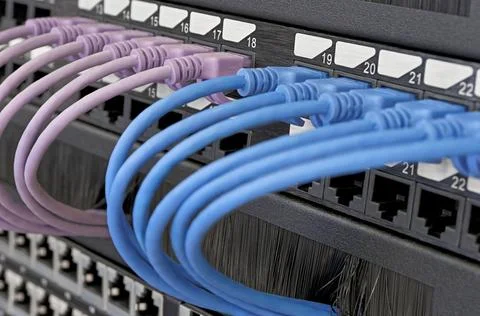 Data center, network panel, switch and connected multi-colored cables Stock Photos