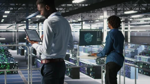 Data center programmer checking lines of code next to colleague Stock Footage 310278325