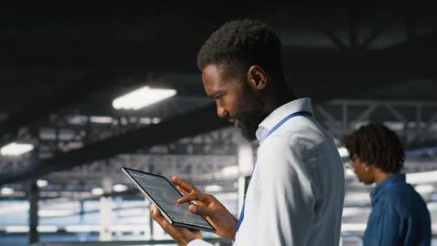 Data center programmer checking lines of code next to colleague Stock Photos