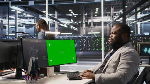 Data center programmer coding on green screen PC, monitoring AI systems Stock-Fotos