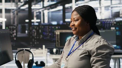 Data center programmer coding on PC, doing software updates for AI systems Stock-Fotos